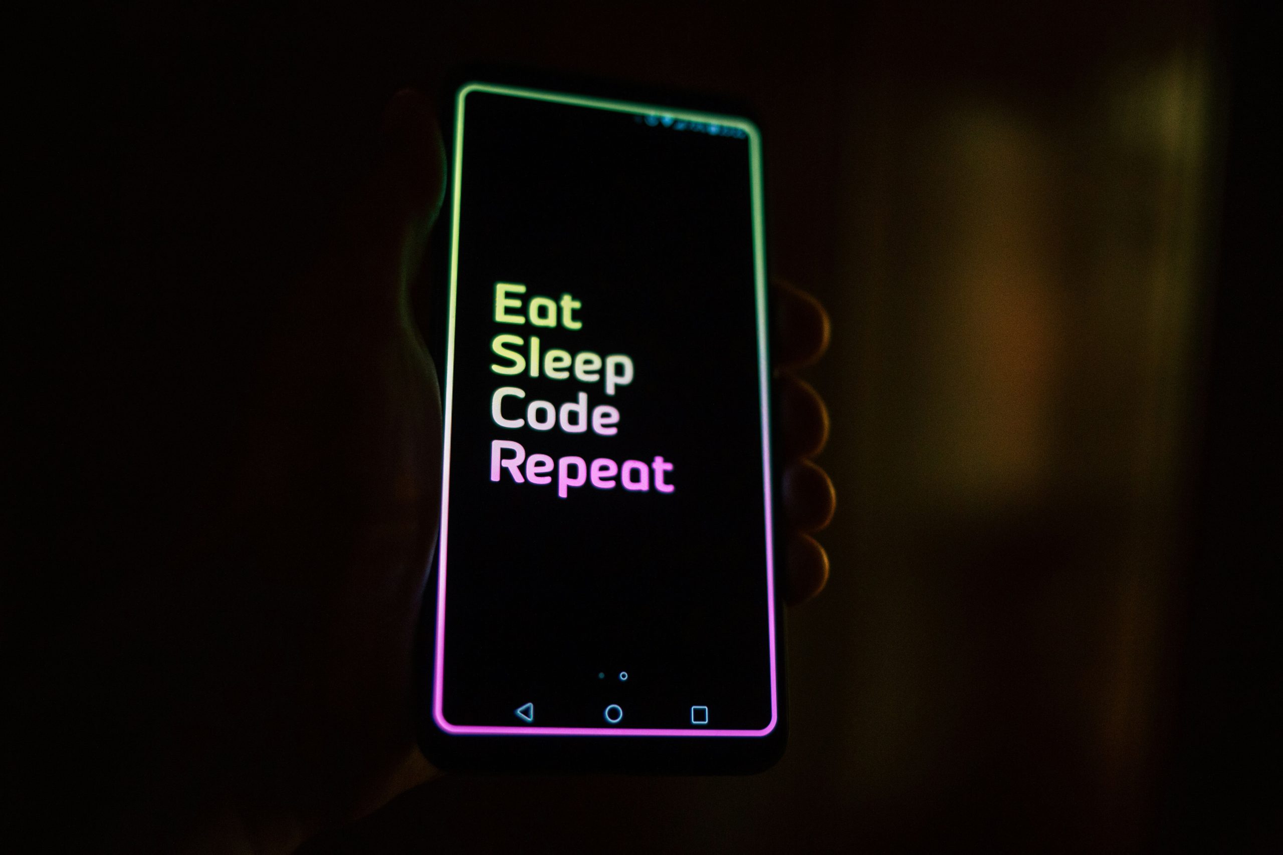 Smartphone in hand during mobile application development and testing