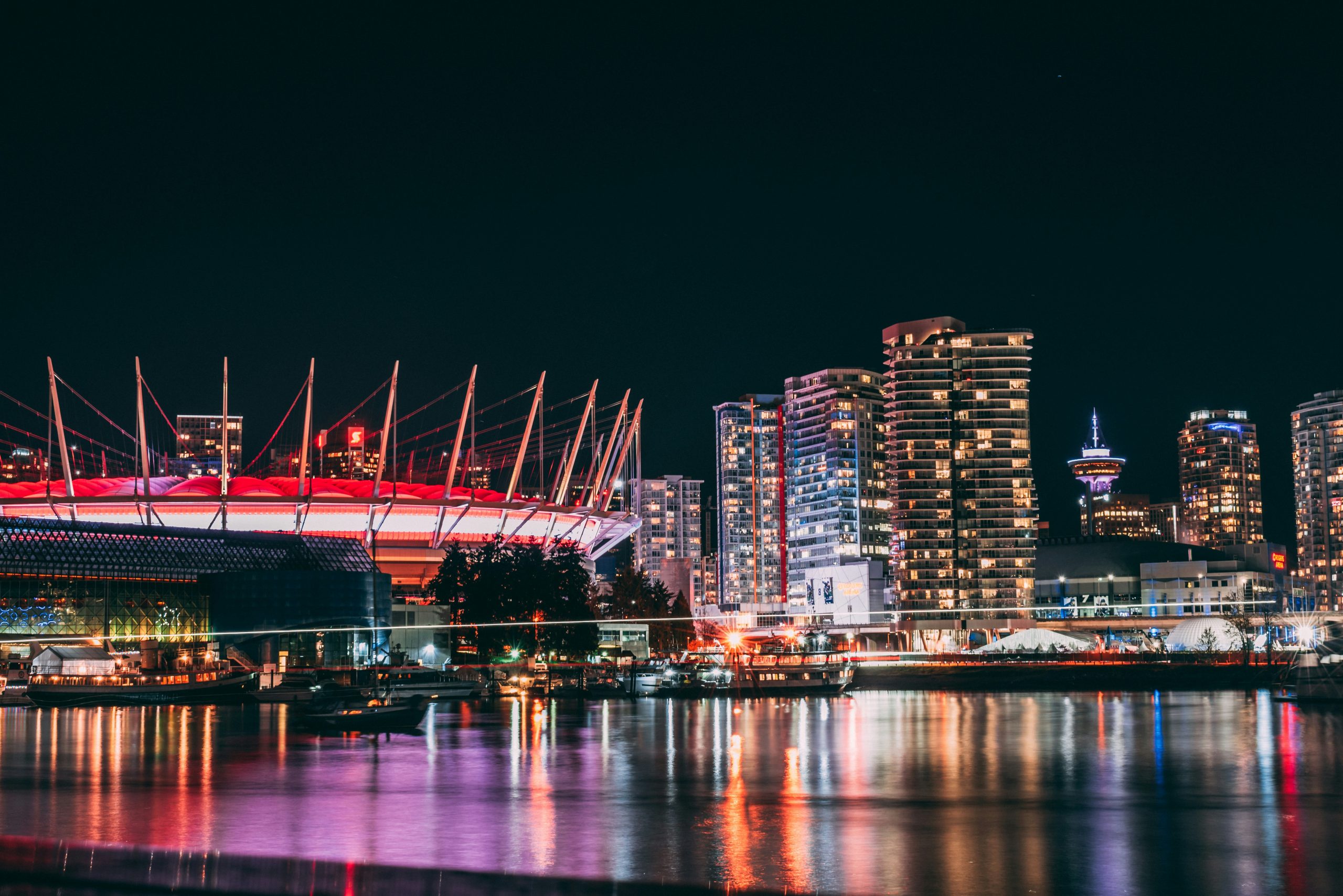 Vancouver city skyline lit up at night, seen across the water